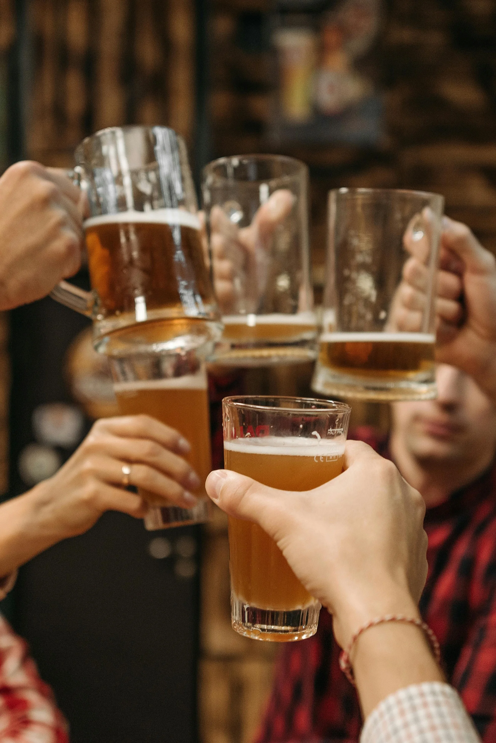 People cheersing pint glasses inside Jack's Wagon