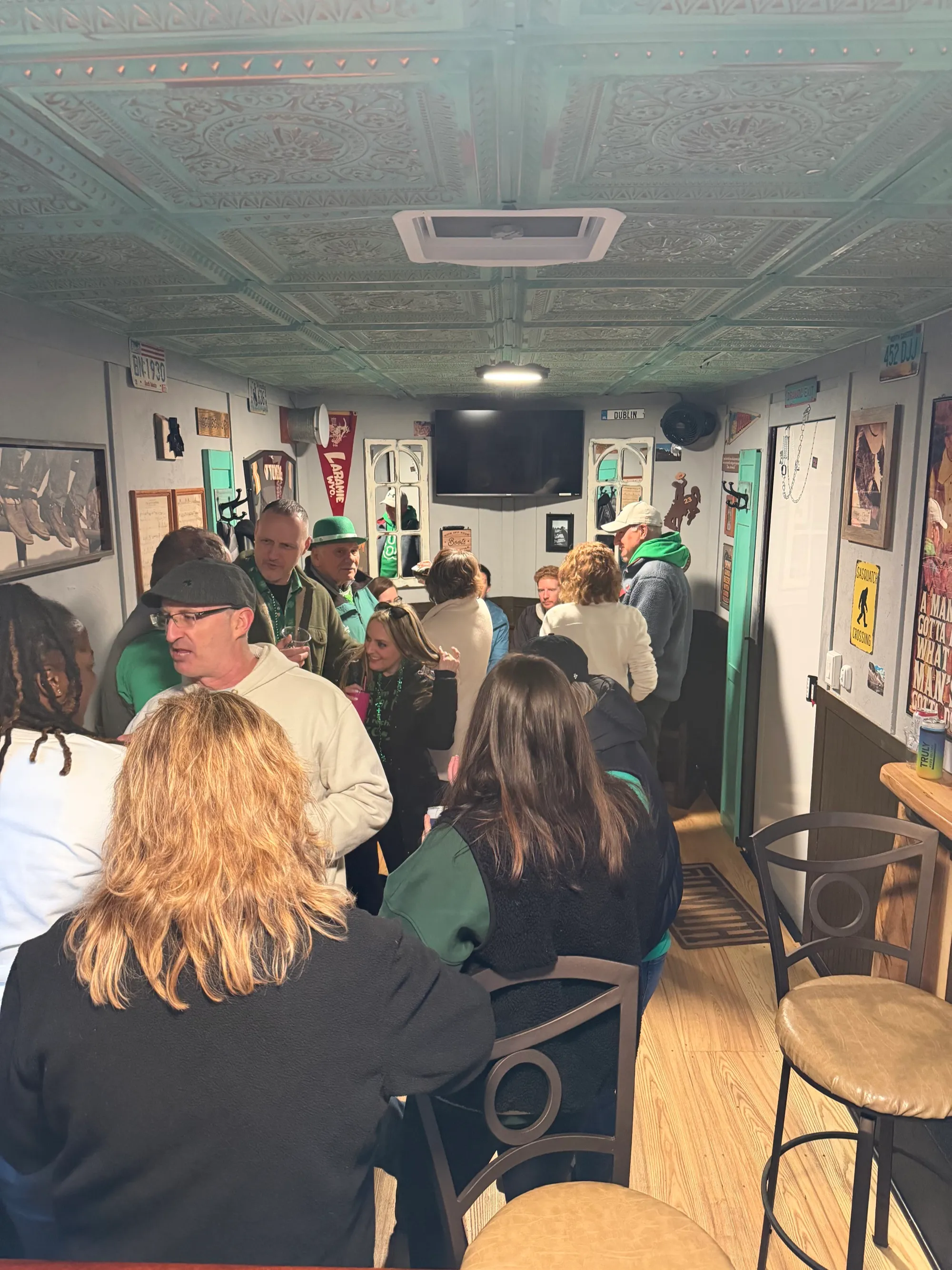 Large crowd inside Jack's Wagon enjoying the mobile pub trailer